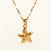Gold starfish pendant on a chain against a white background