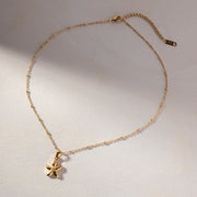 Gold necklace with a starfish pendant on a light background