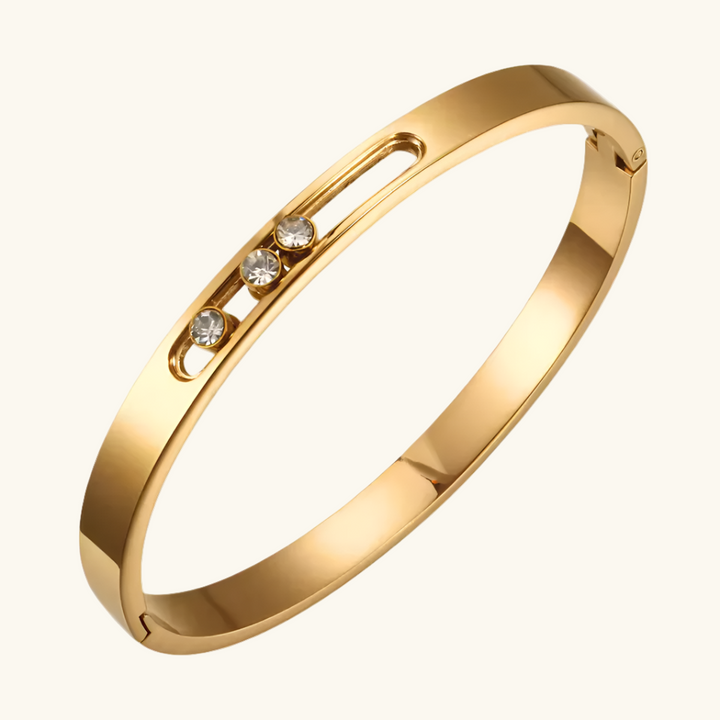 Gold bracelet with embedded diamonds on a white background